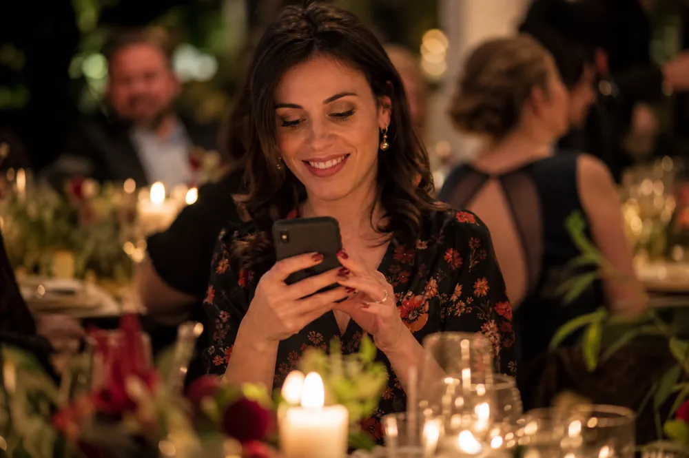 A guest sends photos from her phone during the party
