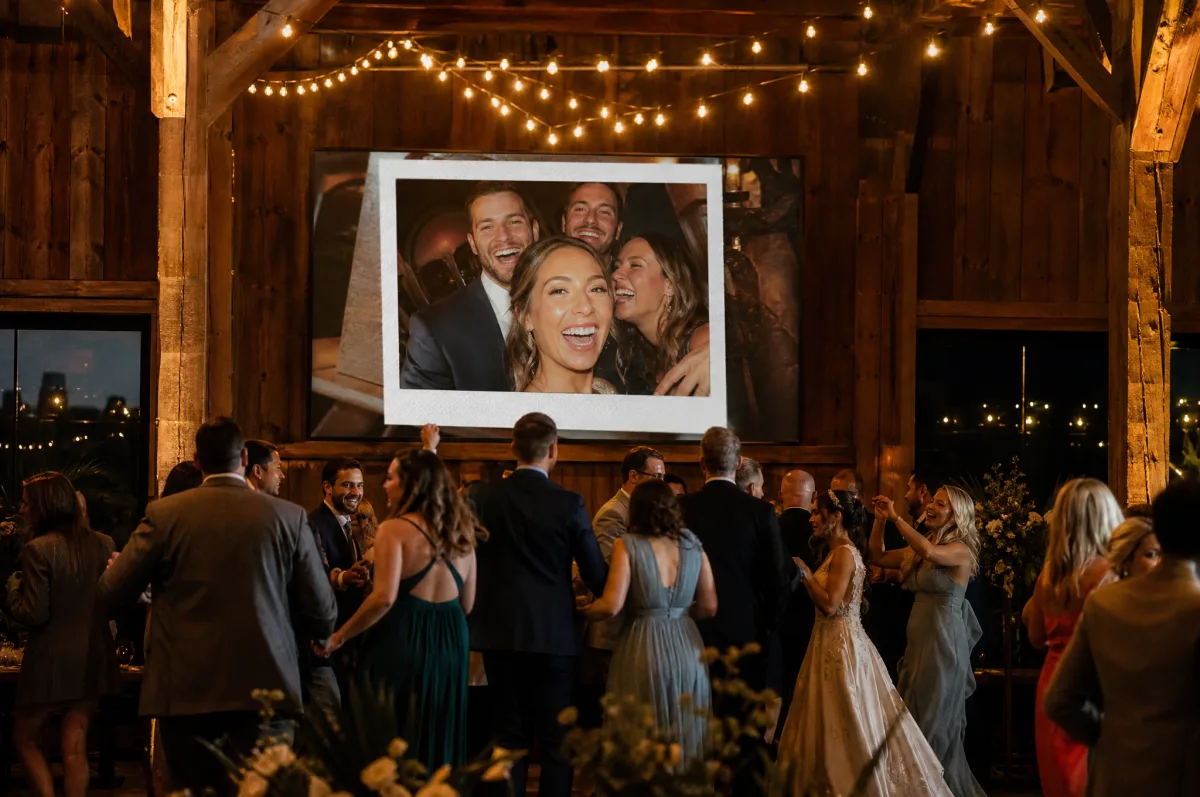 A barn wedding at night, a guest photo shown on a big screen